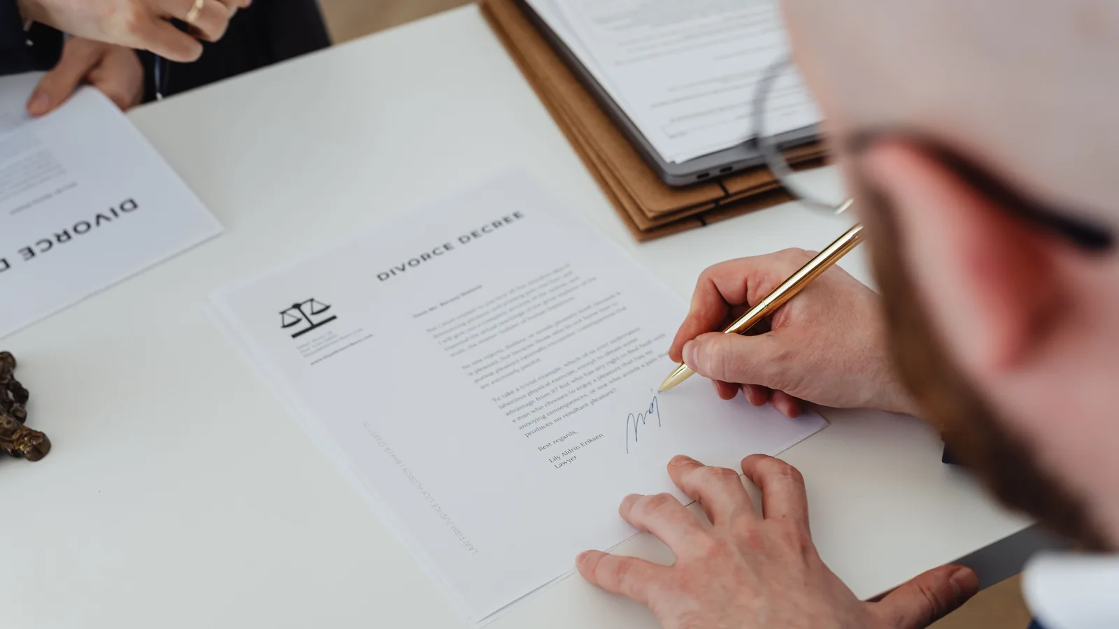 Divorce document being signed on a legal office desk