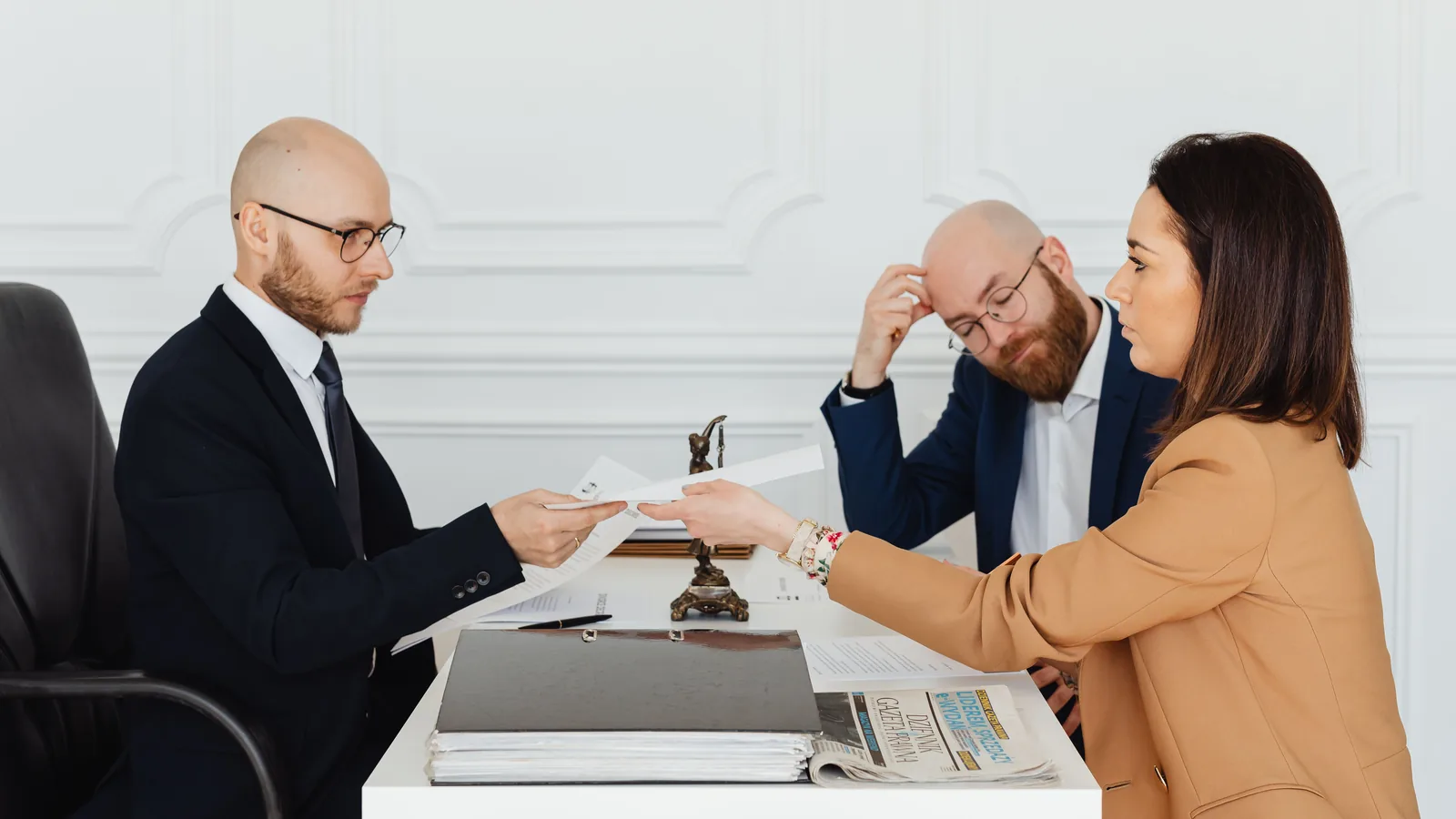 Law office discussion with documents on the table