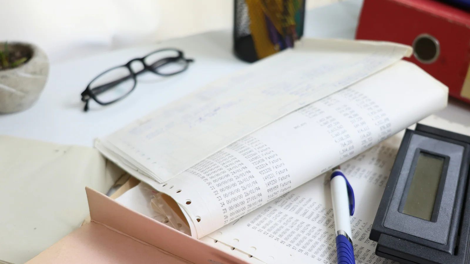 Desk with papers, calculator and office supplies
