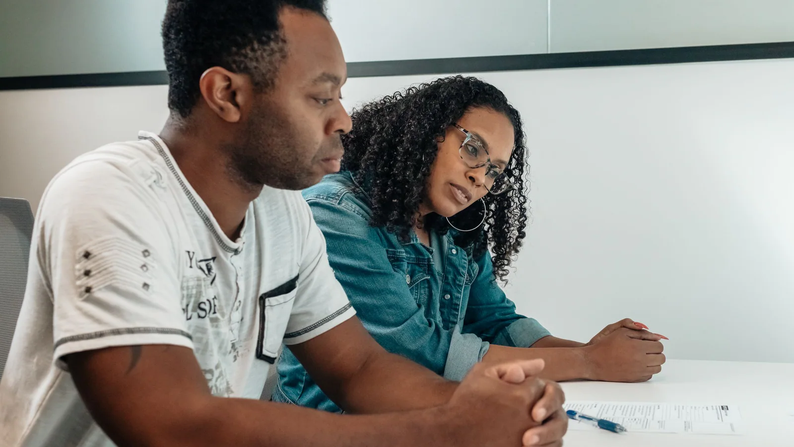 Two adults reviewing a document at a meeting table
