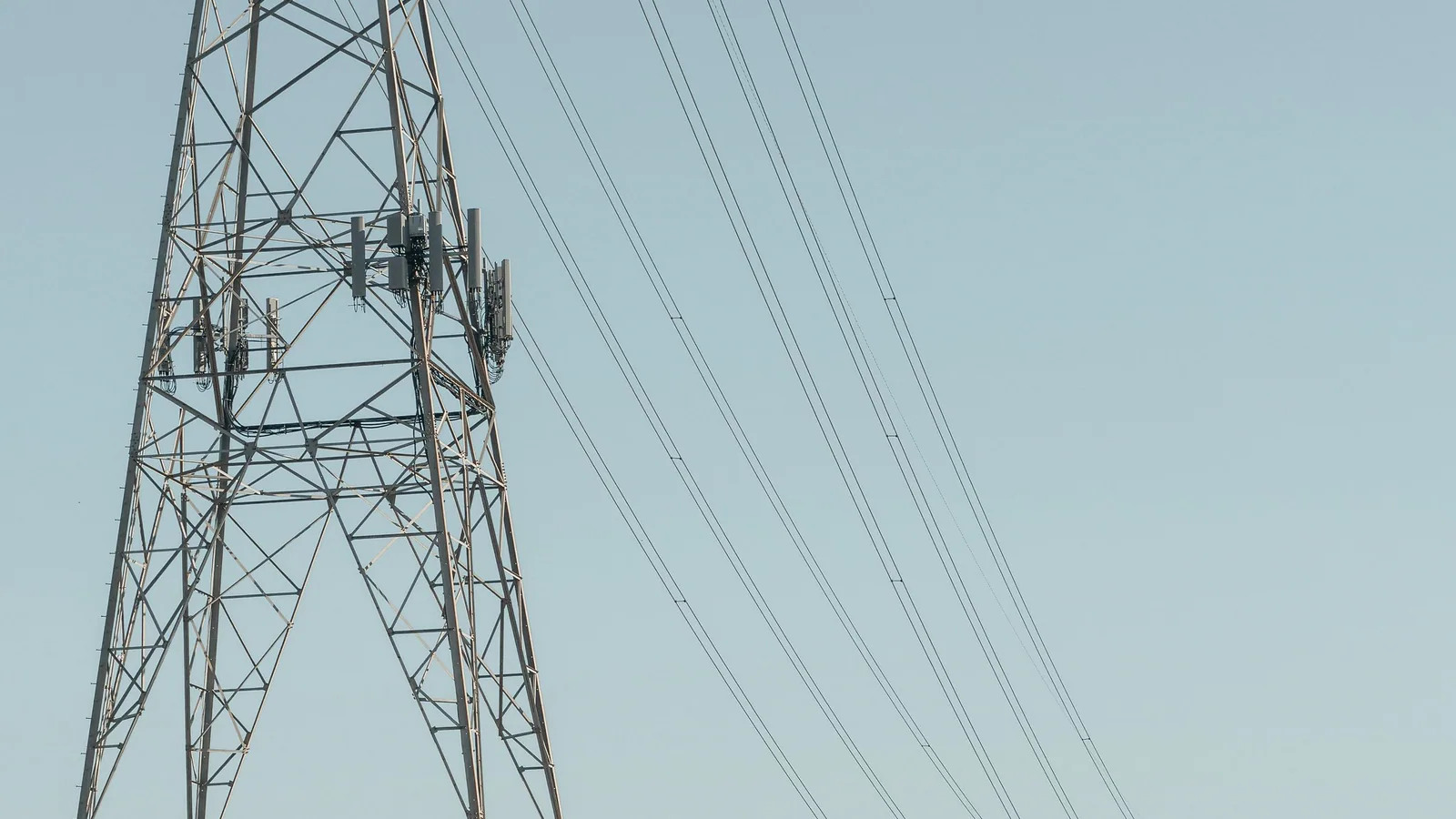 Electricity transmission towers and power lines crossing open land