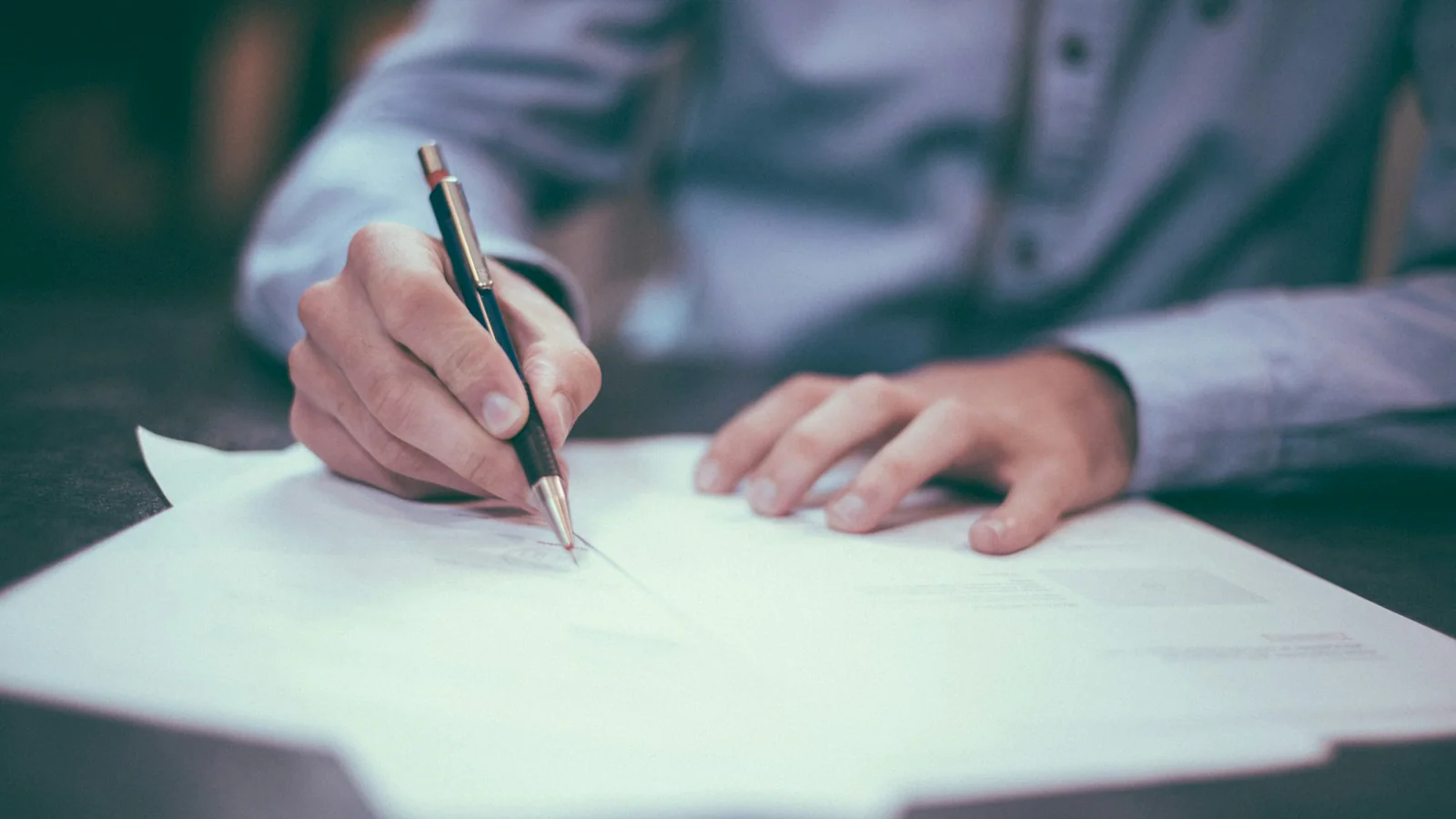 Hands organising an unreadable debt-collection document file