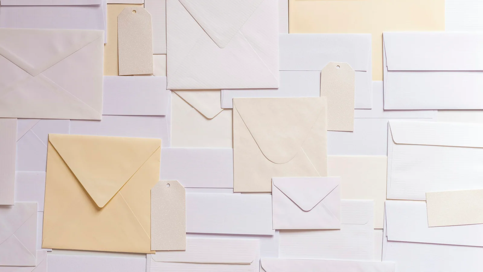Blank envelopes and paper tags arranged on a flat surface