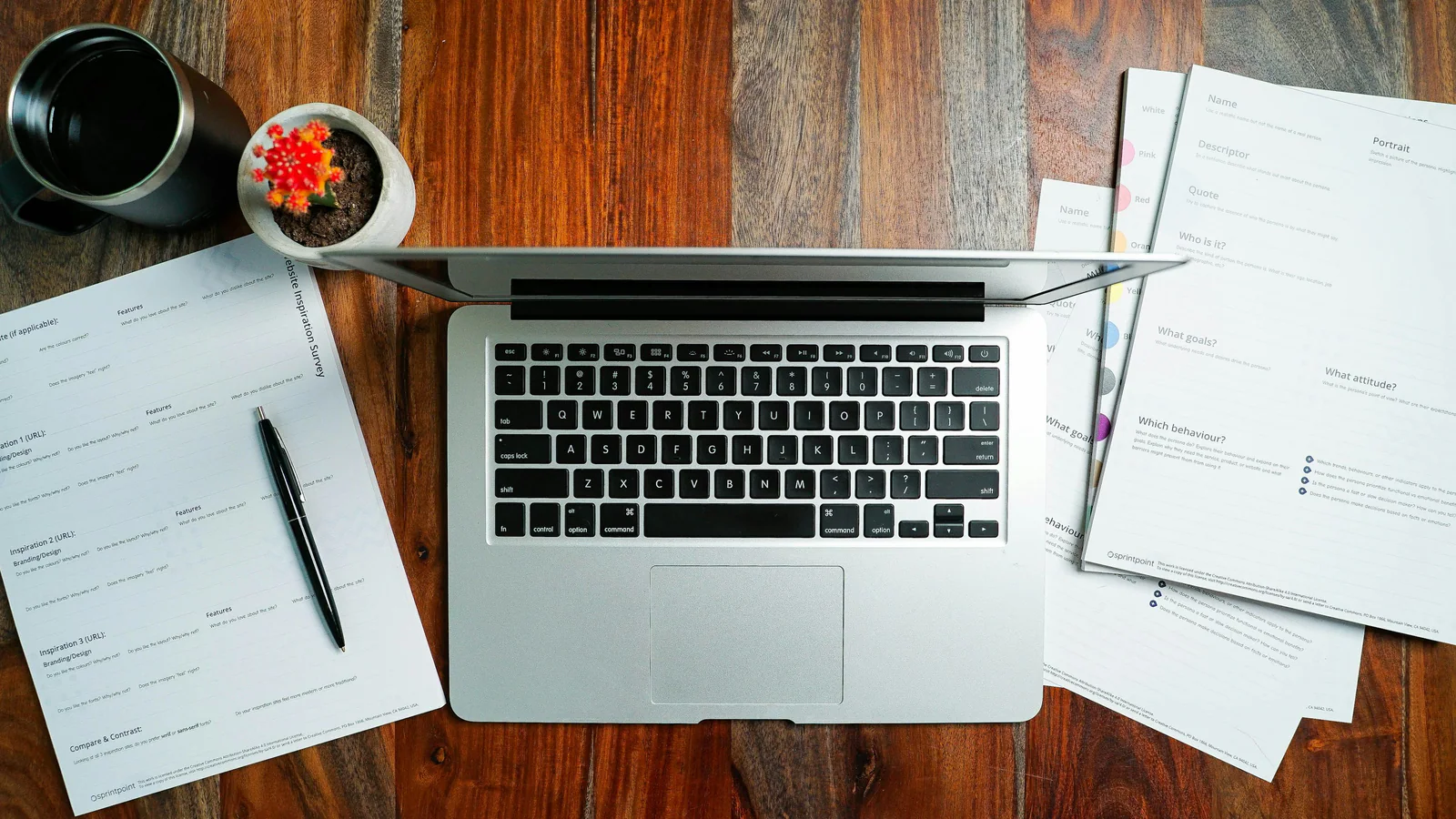 Laptop and papers on a desk used as a small-business transaction document metaphor