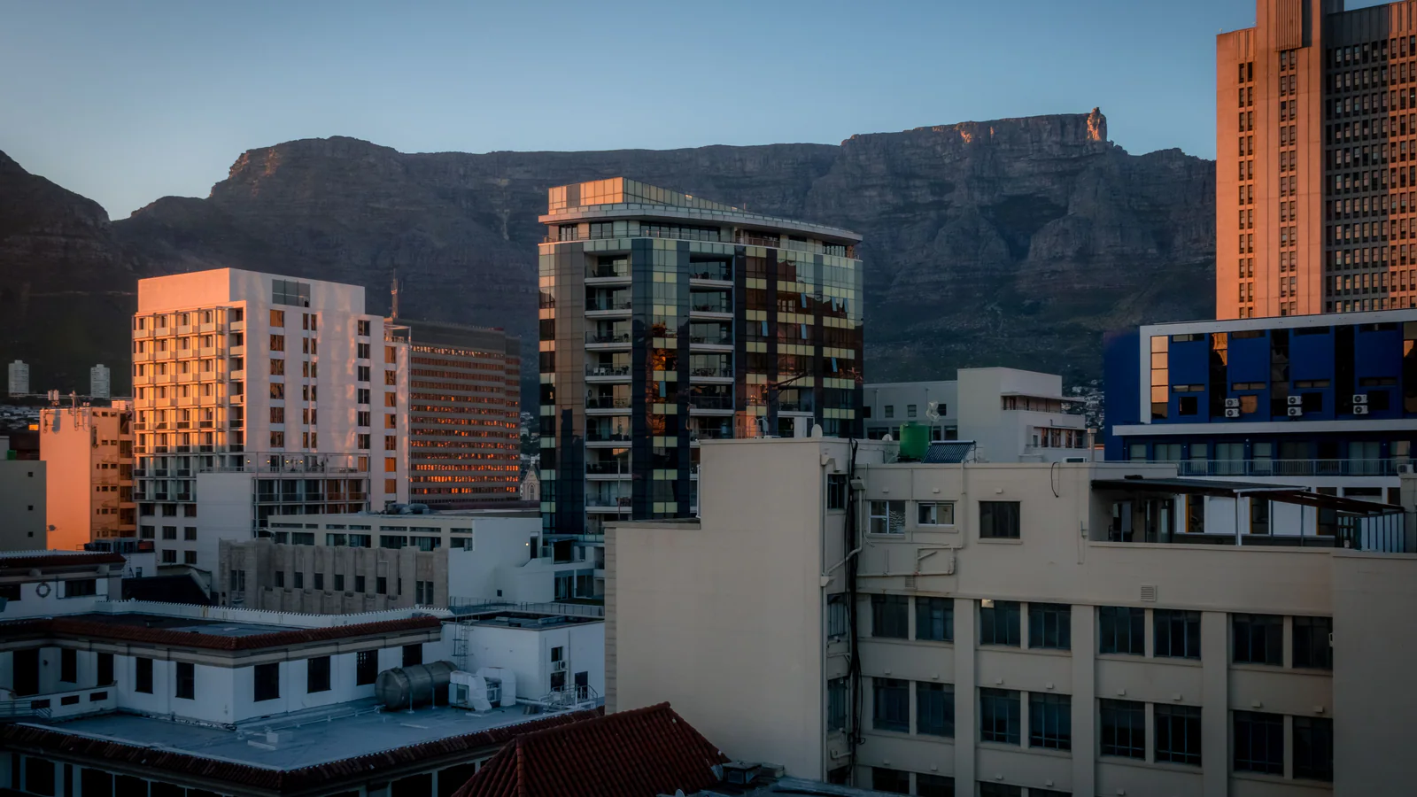 Cape Town buildings in front of Table Mountain at dusk