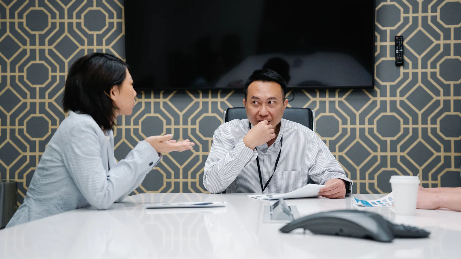 Professionals listening and speaking during a meeting