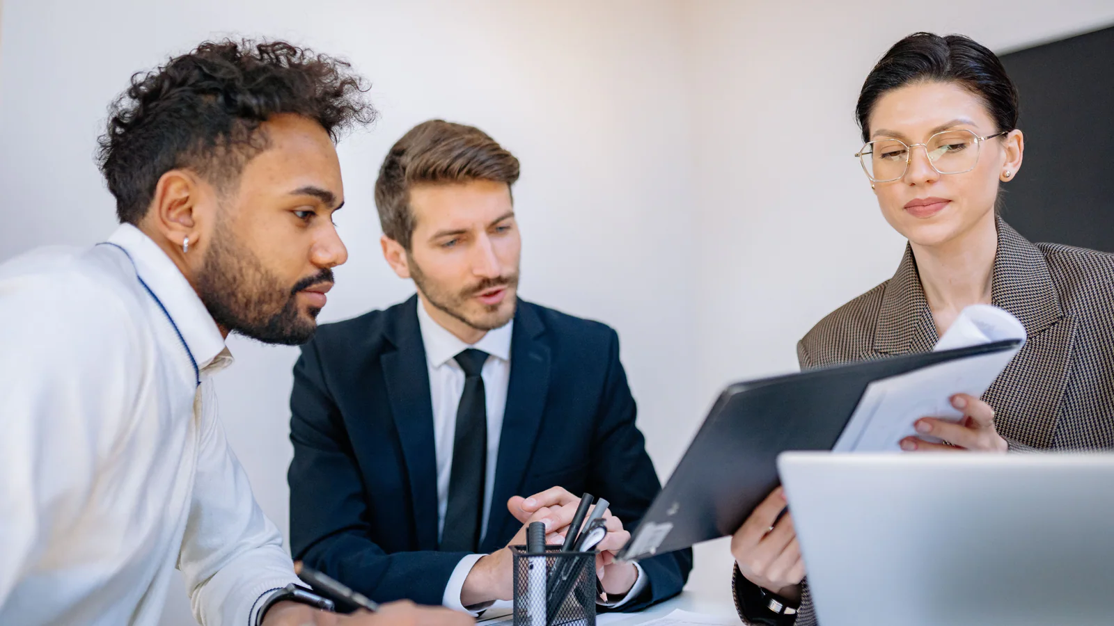 Coworkers reviewing a document during a workplace meeting