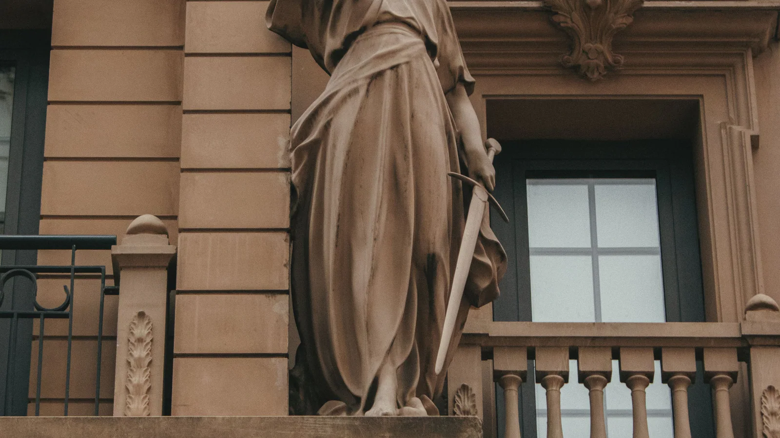 Carved justice figure on a historic civic building