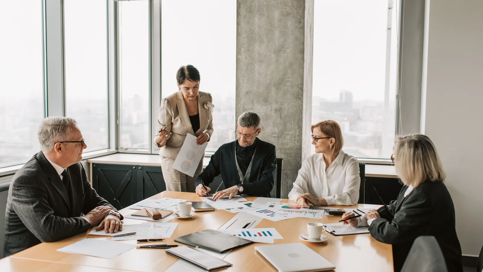 Business professionals discussing documents in a meeting room