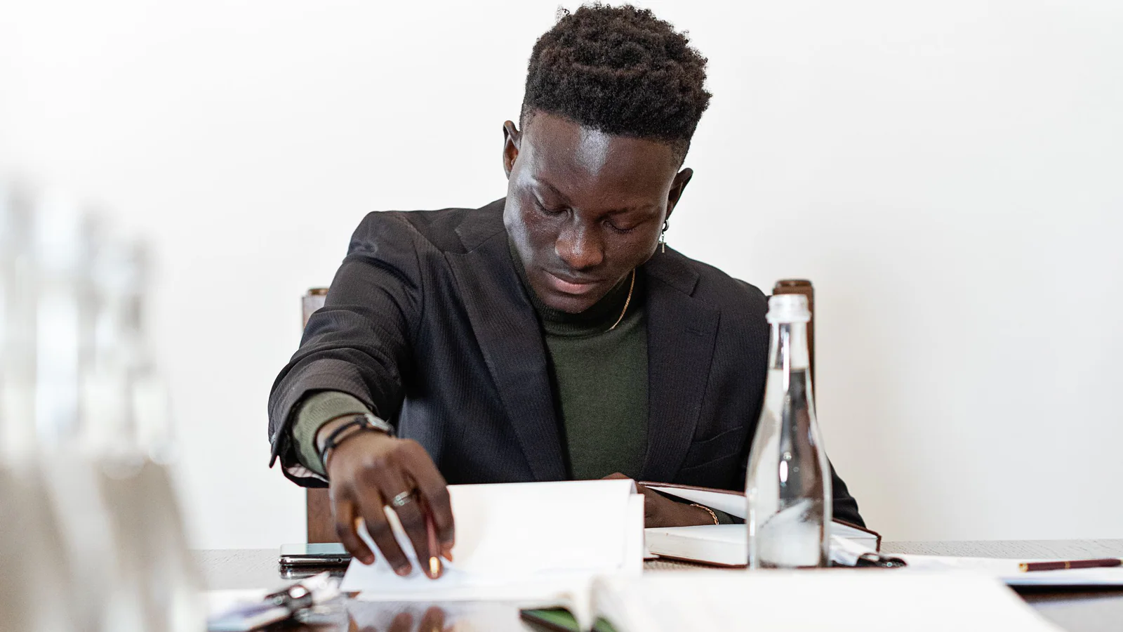 Person reviewing and organising documents at an office table