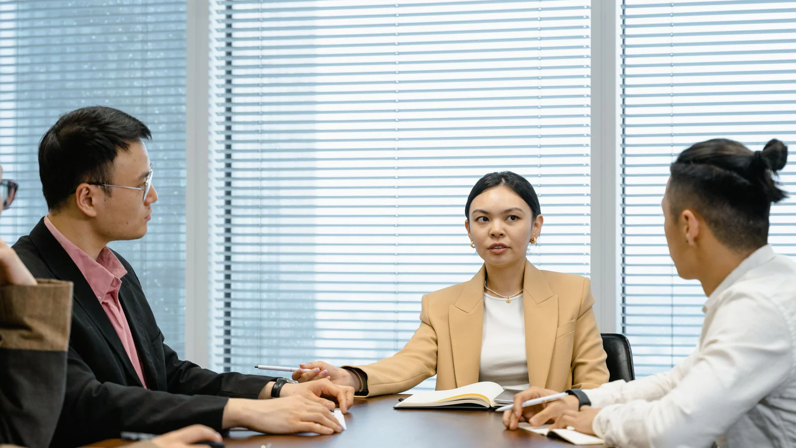 Business group having a structured discussion around an office table