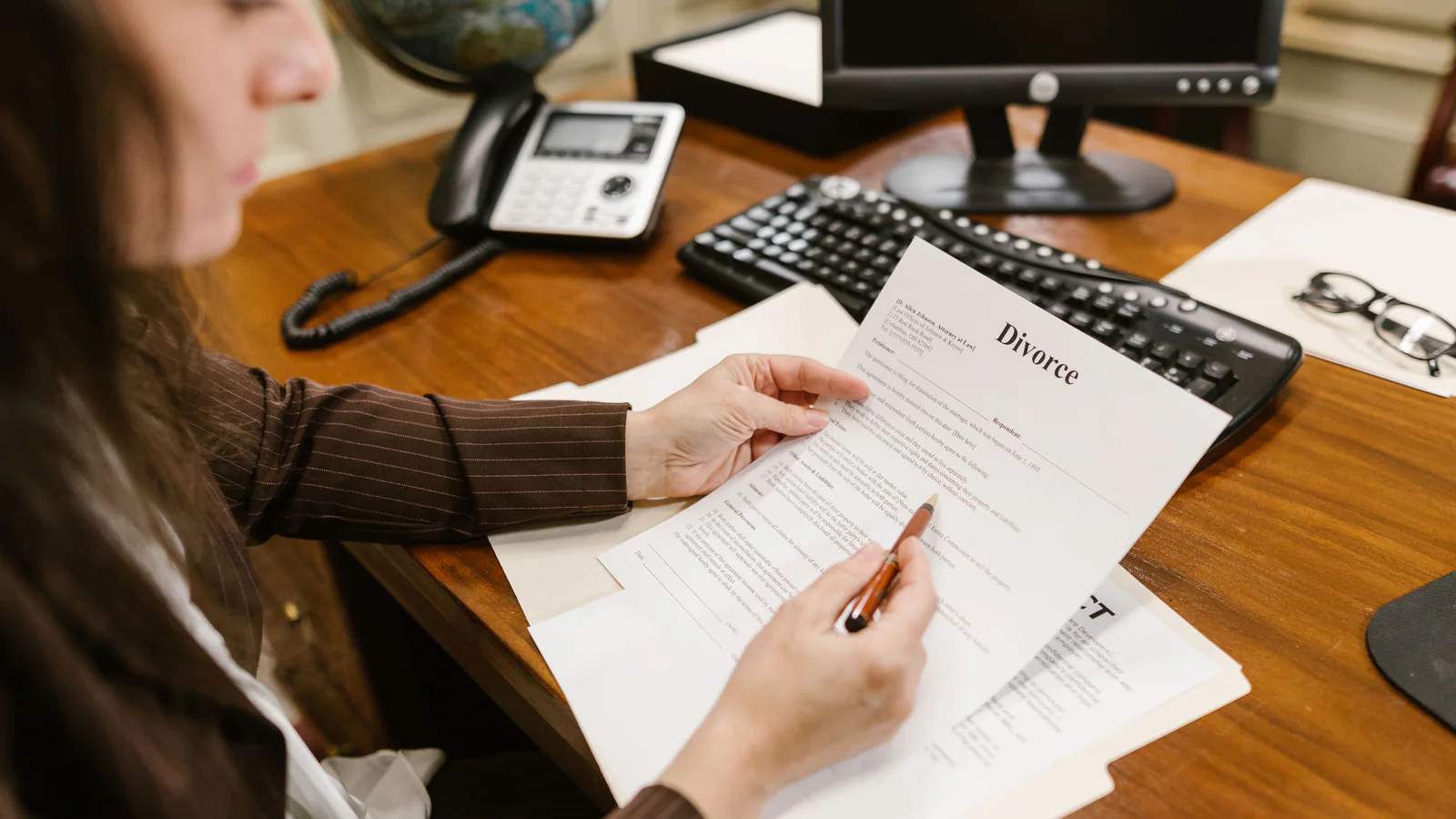 Professional reviewing documents at an office desk