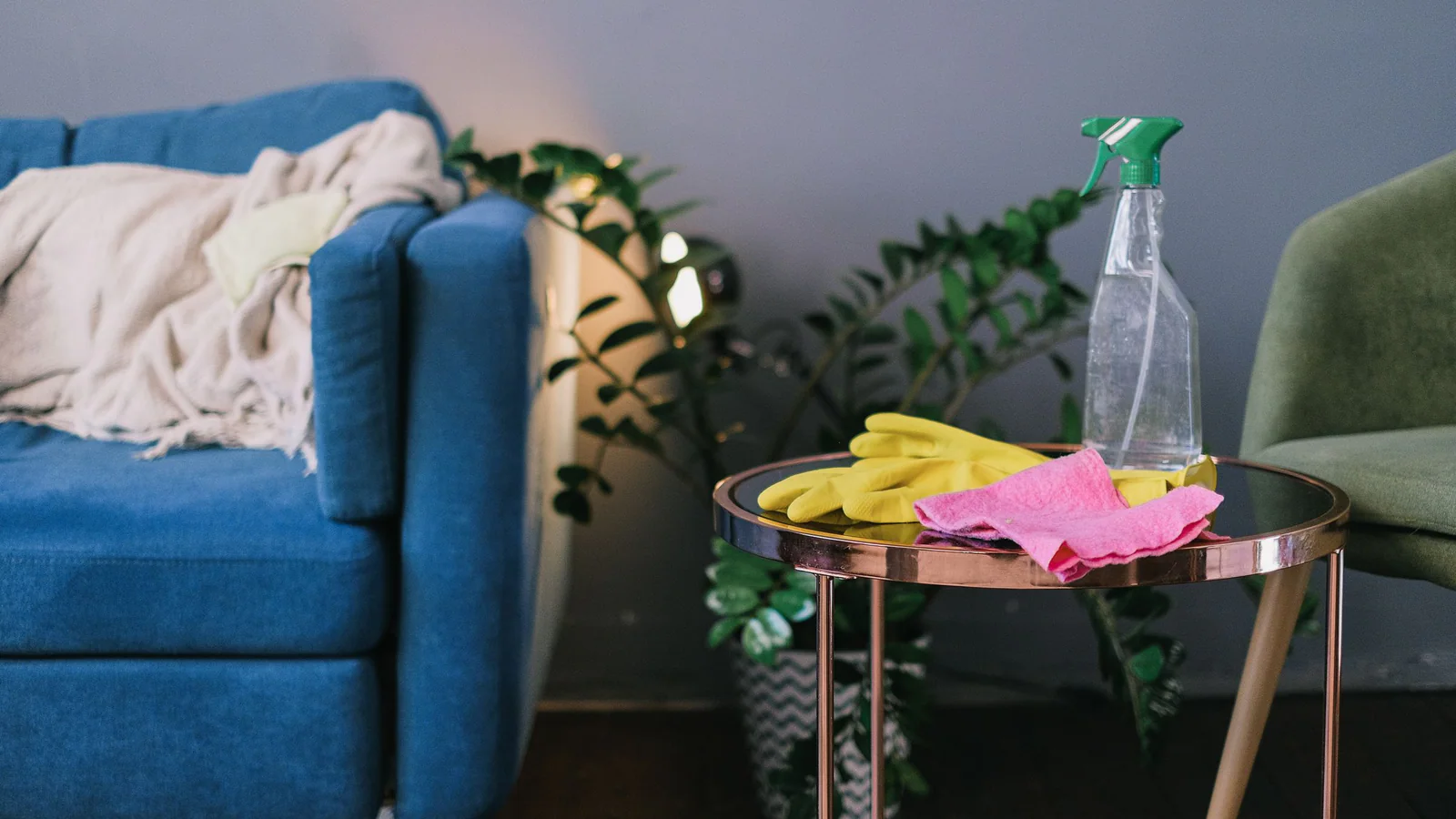 Cleaning supplies and gloves arranged on a table in a home