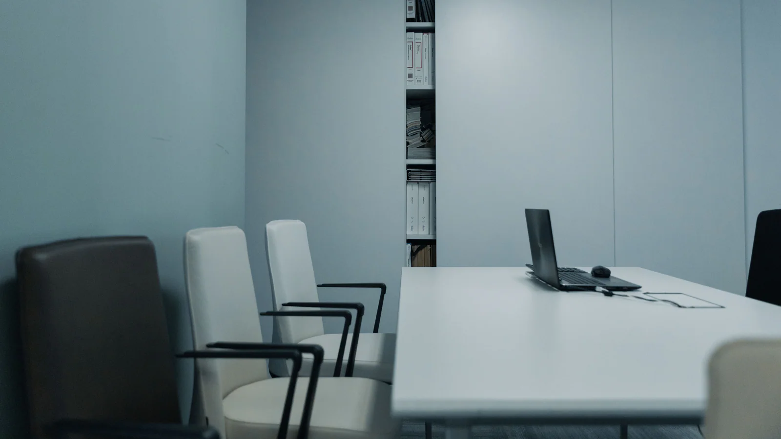 Empty conference room with chairs and a laptop on the table