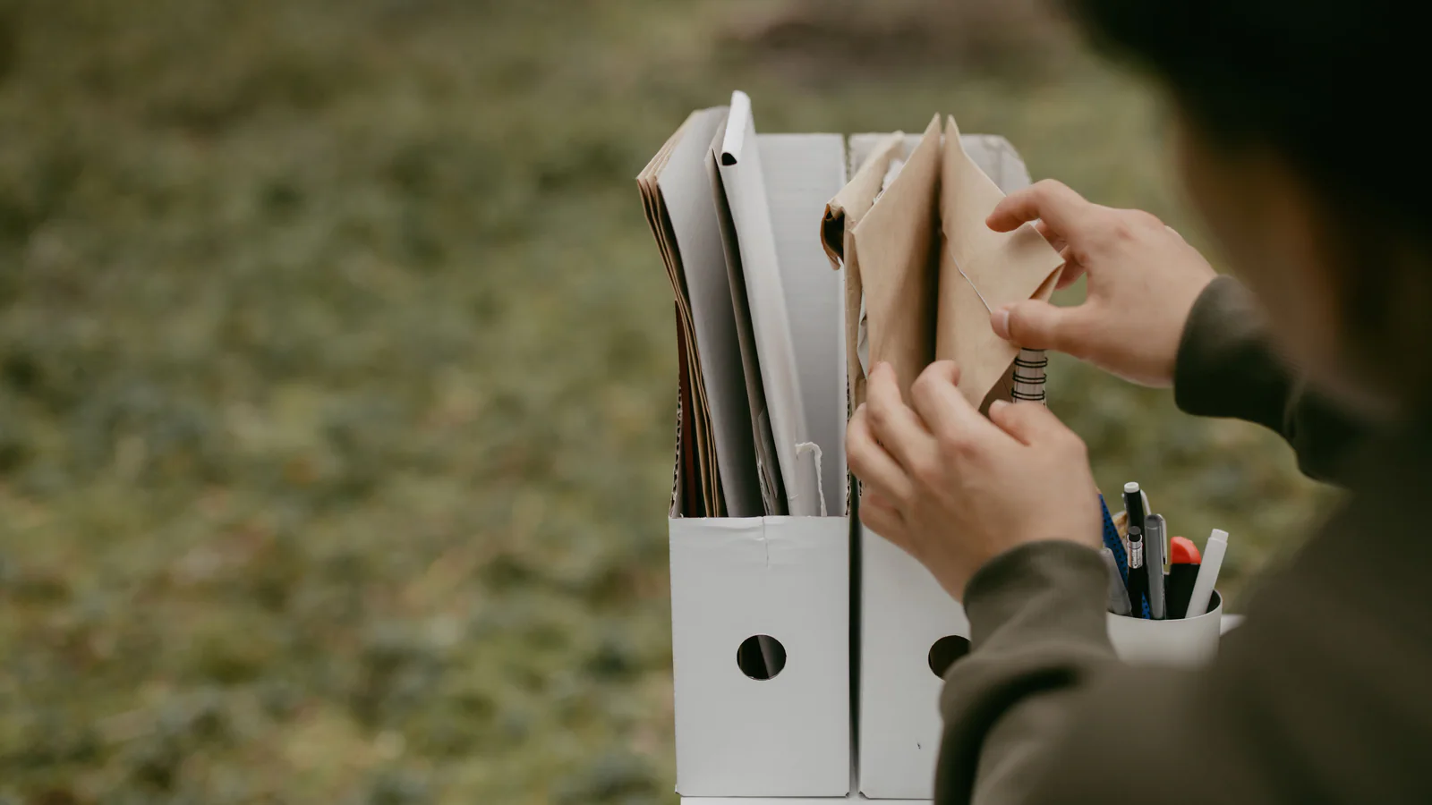Person choosing a folder from an organised set of documents
