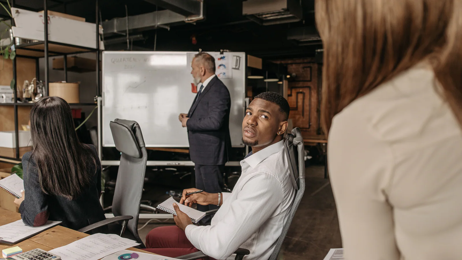 Workplace team discussing documents in a meeting room