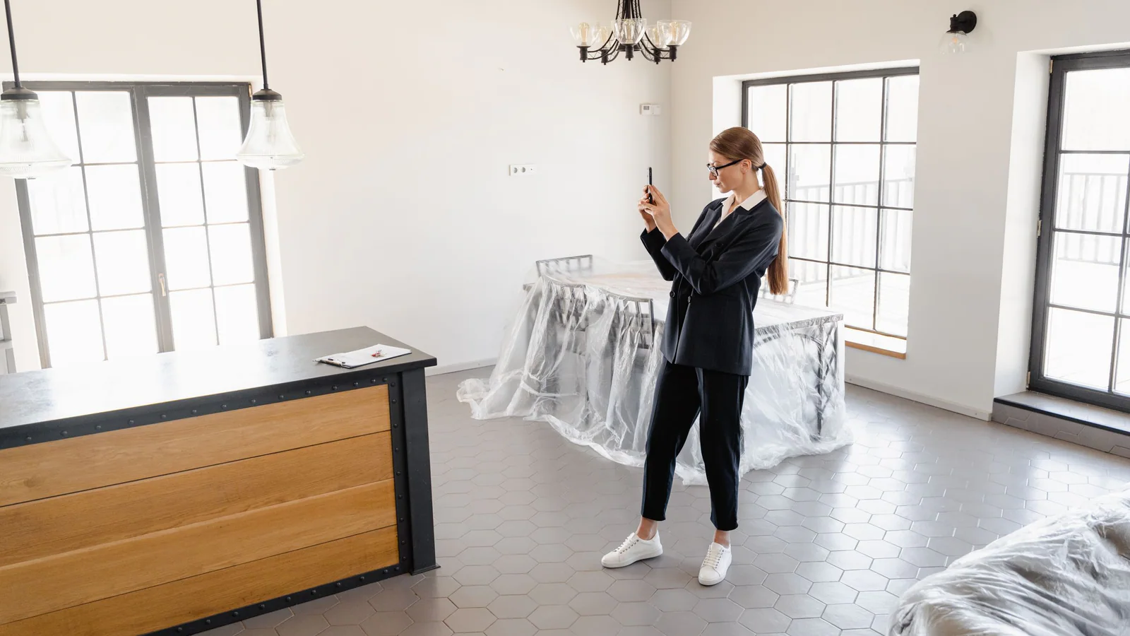 Person photographing the condition of an empty home interior