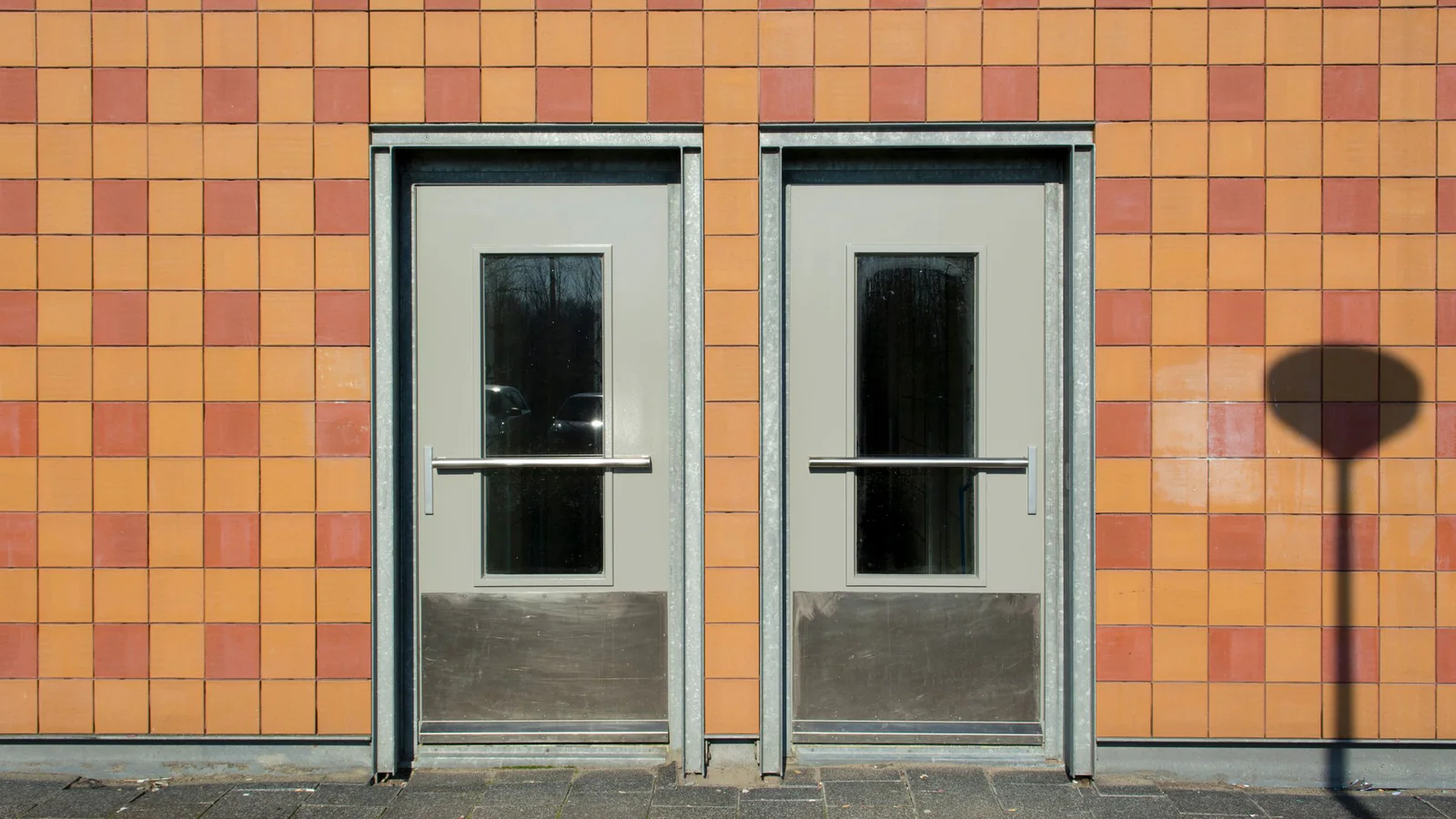 Two similar unlabelled doors side by side