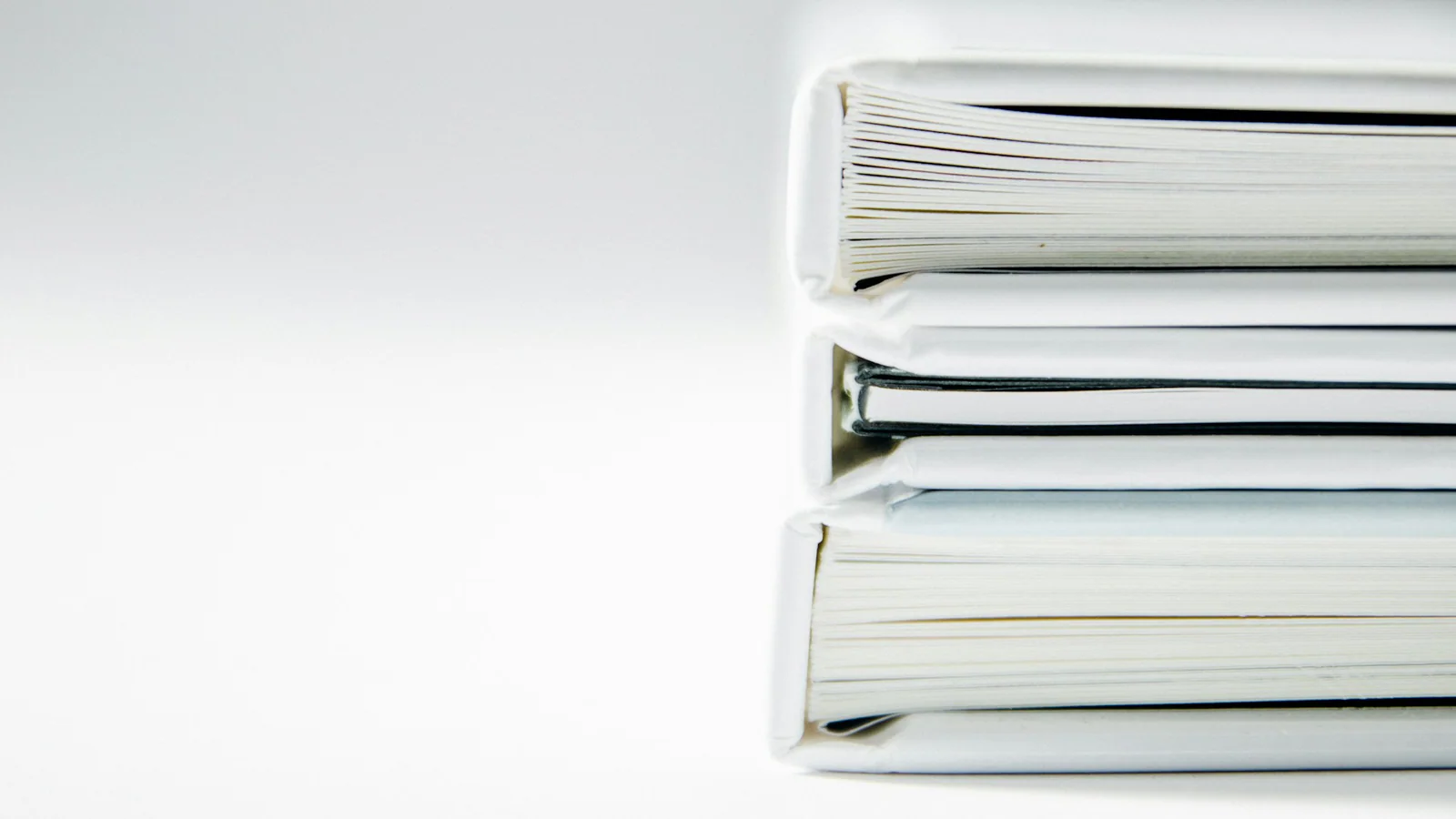 Stack of plain white folders representing historical debt records