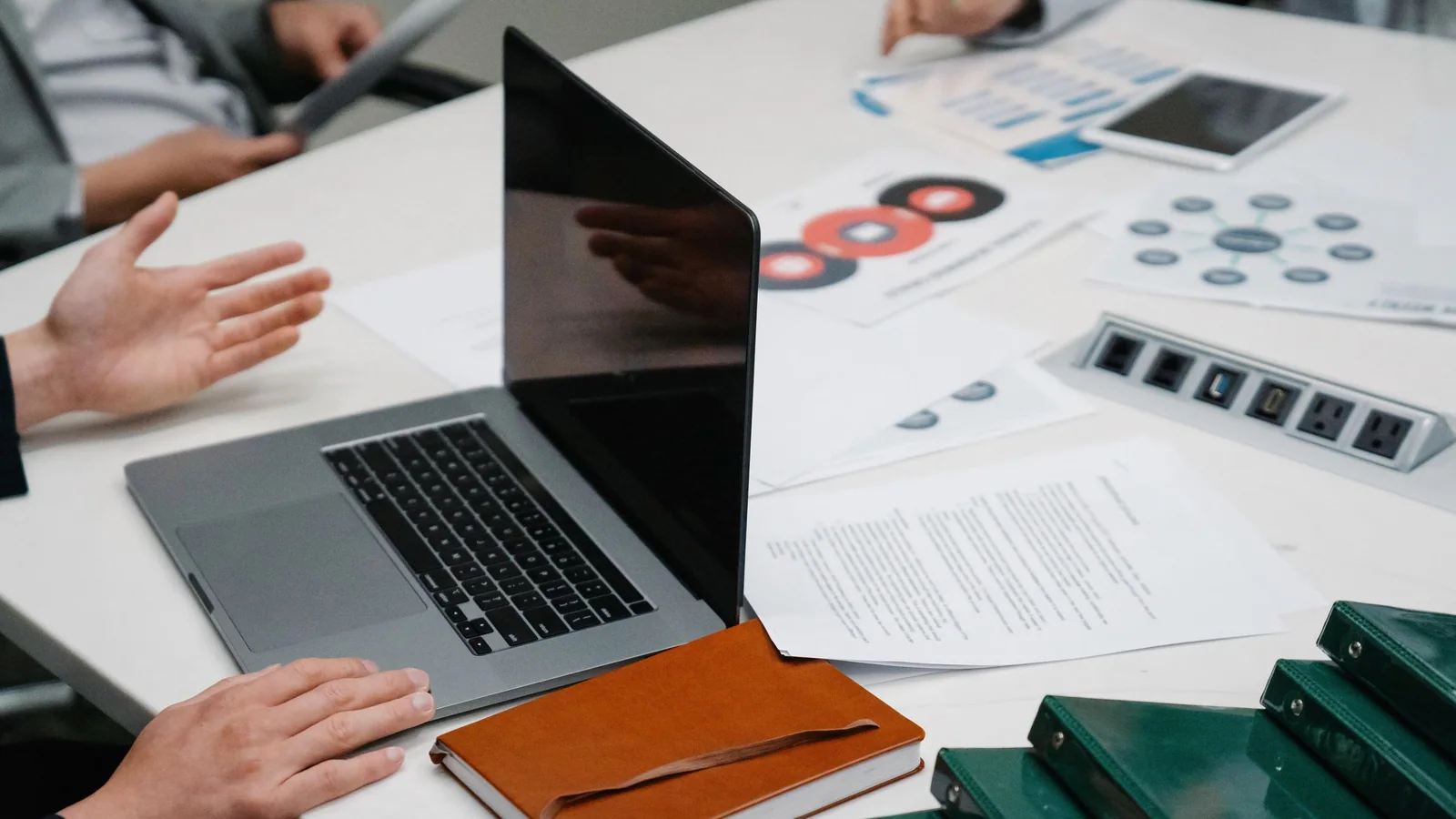 People reviewing charts around a meeting table