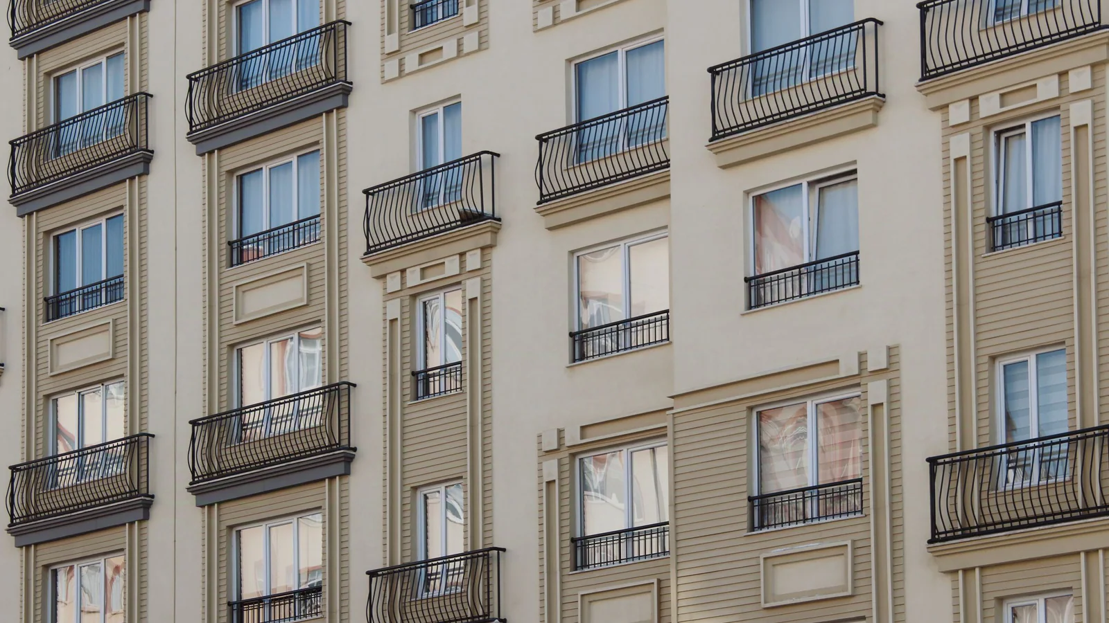 Apartment building facade with repeating windows and balconies