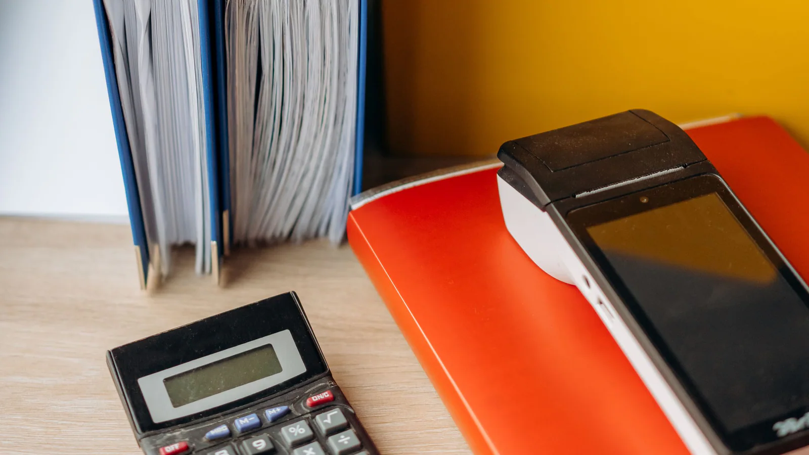 Office files and calculator arranged on a desk
