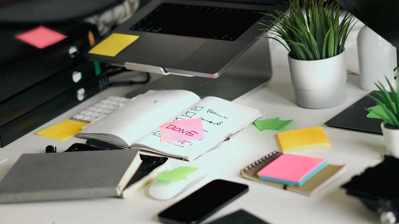 Laptop and open checklist on an organised office desk