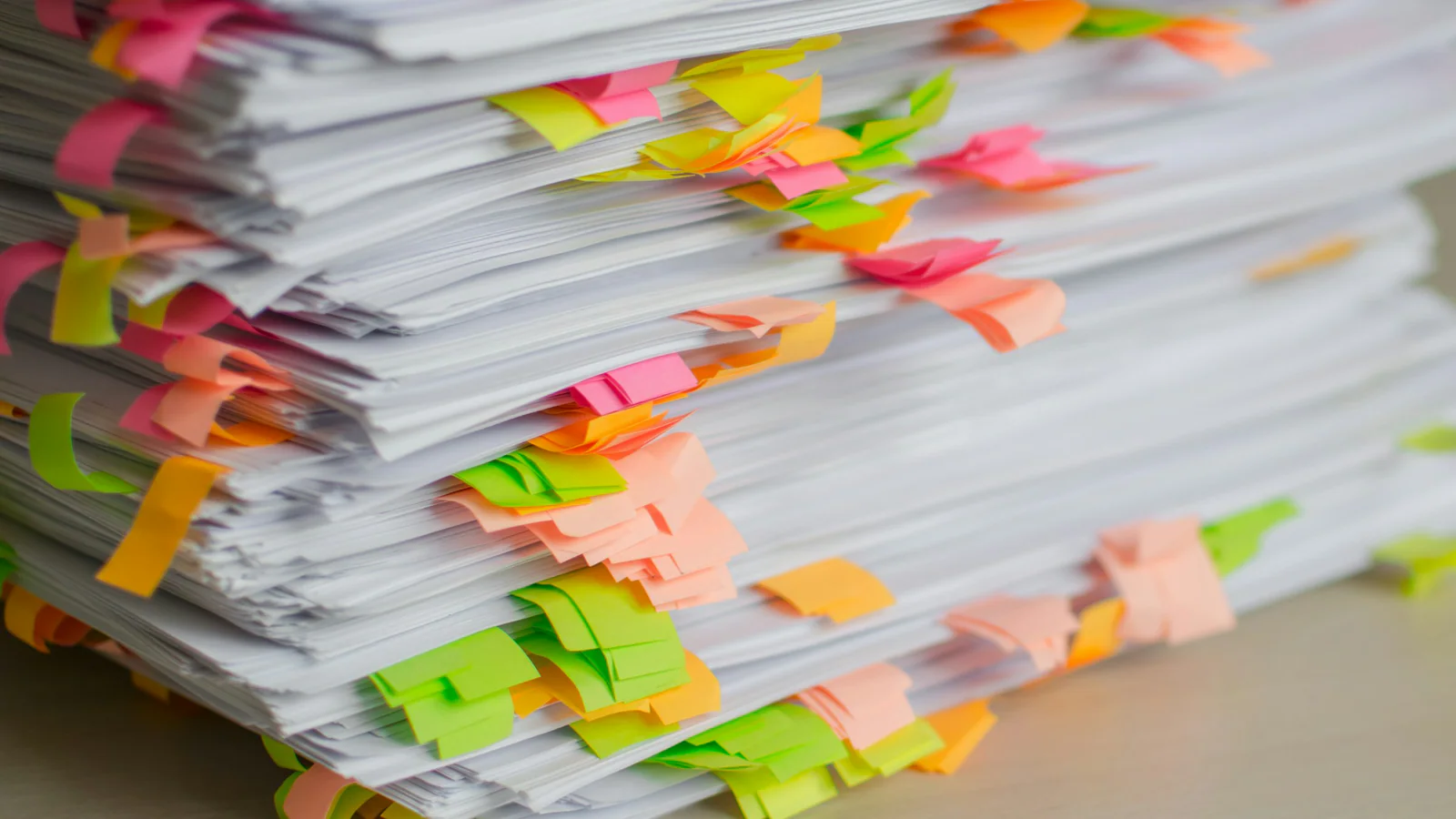 Stack of documents marked with colourful indexing tabs