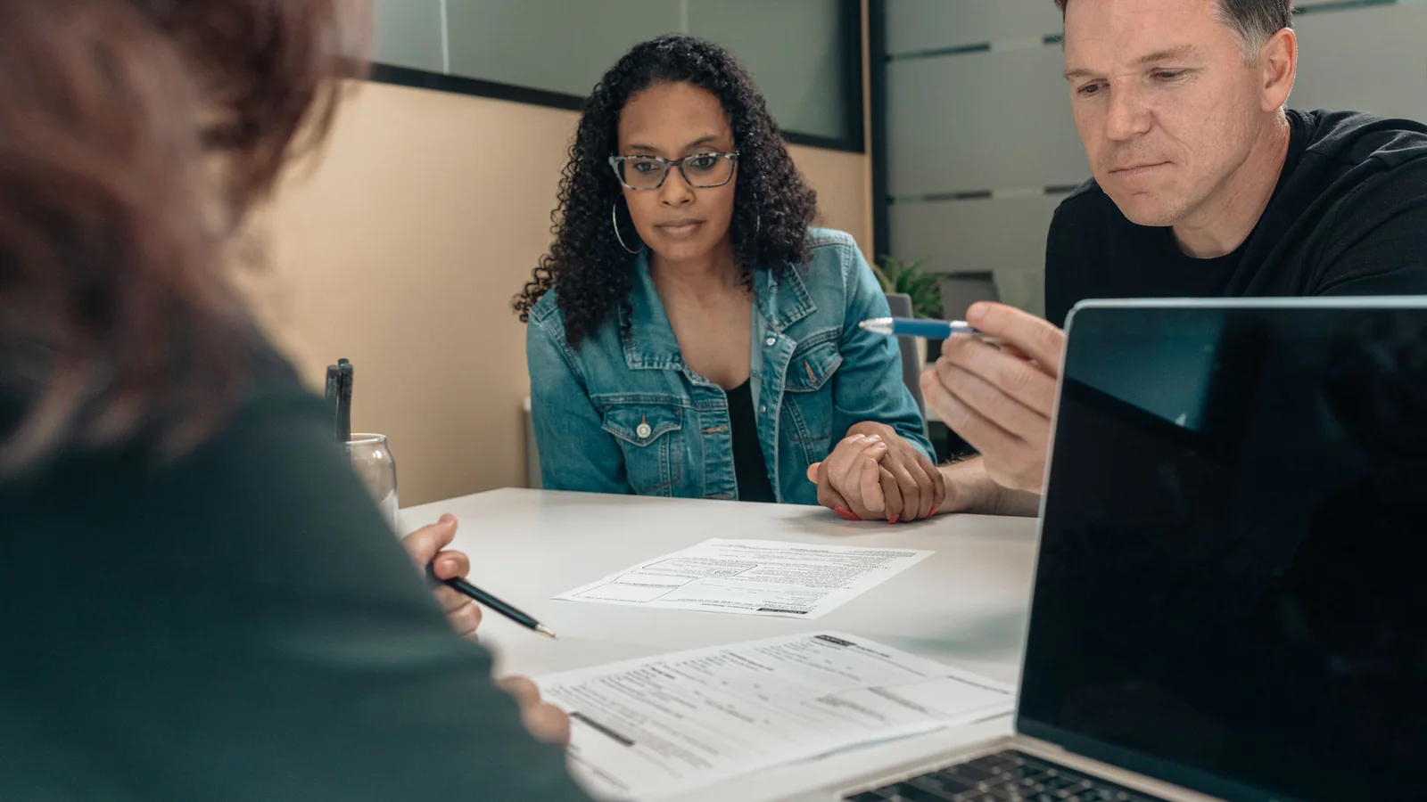 Two adults reviewing documents in a professional meeting