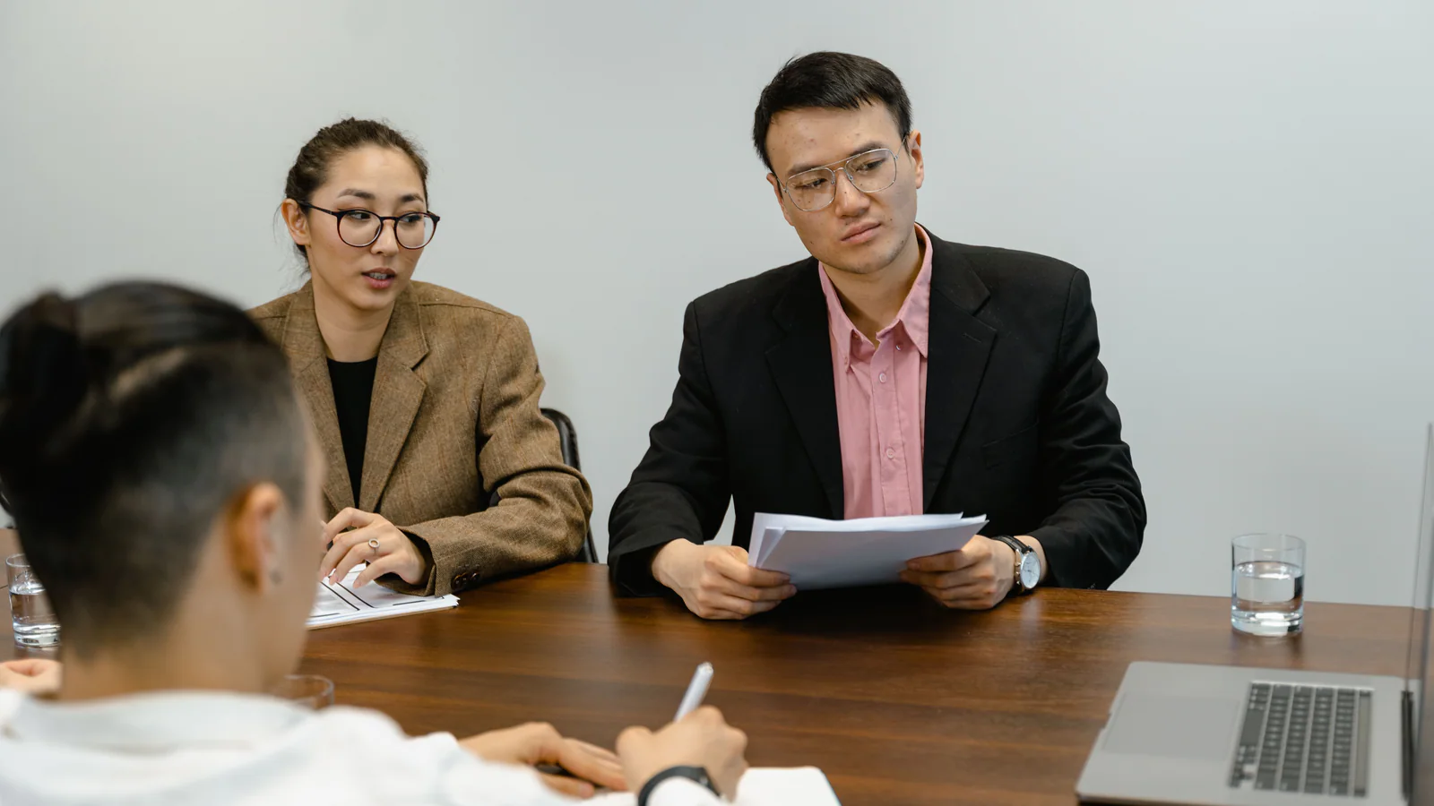 Colleagues discussing documents during an office meeting