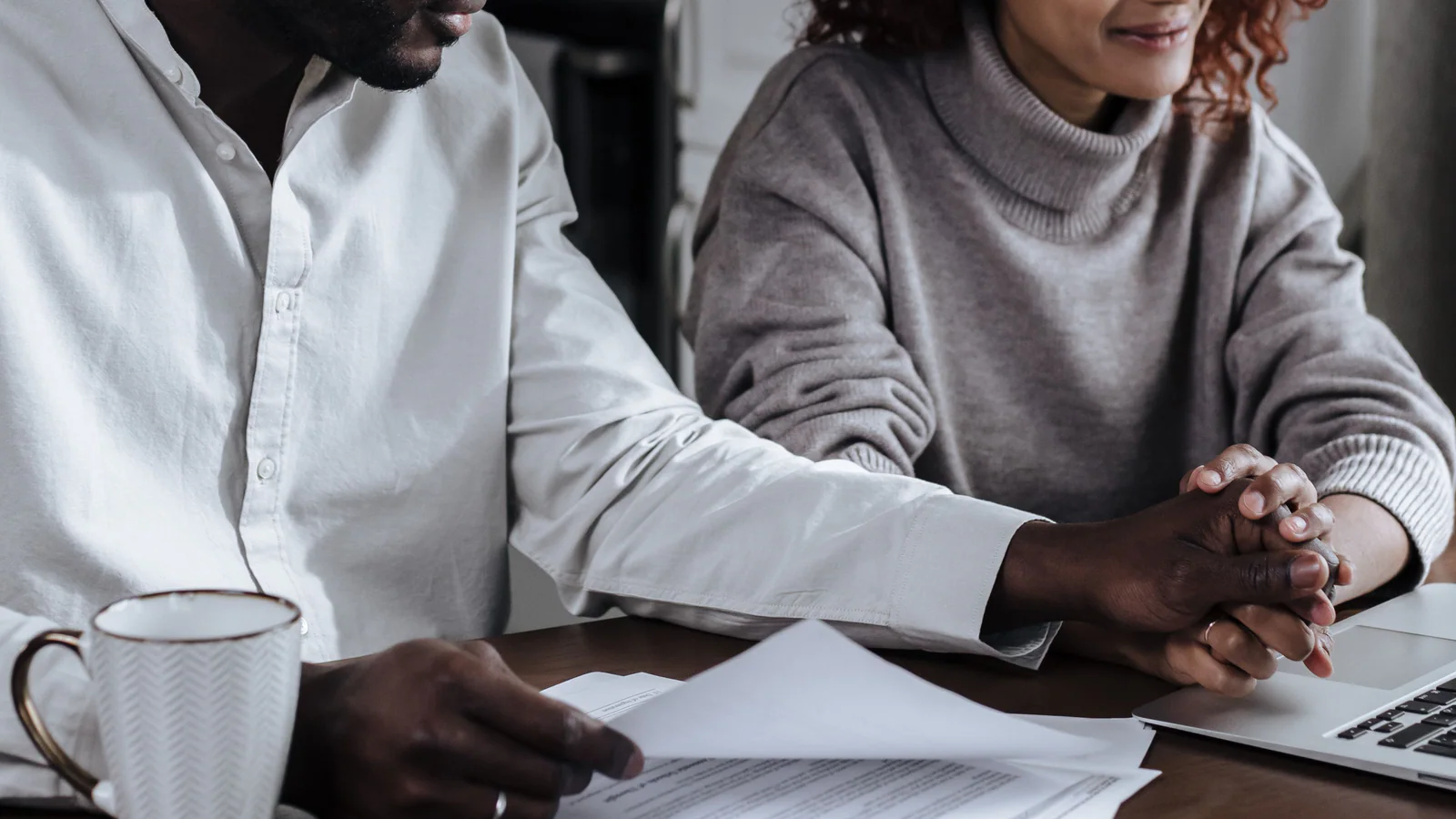 Couple reviewing household planning documents at a table
