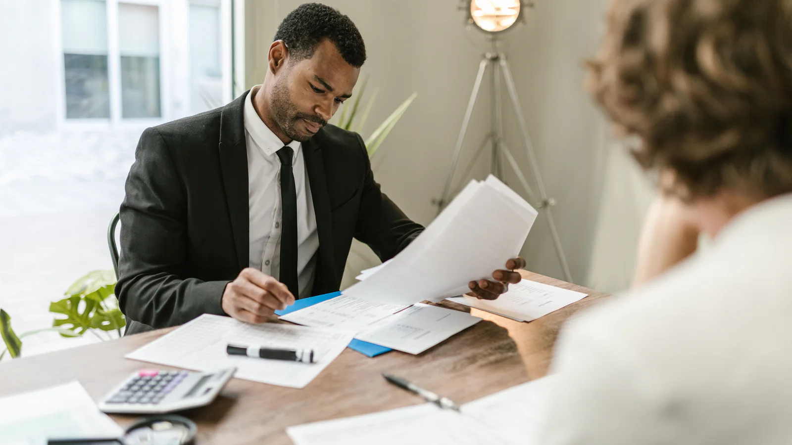 Two people reviewing documents at an office table