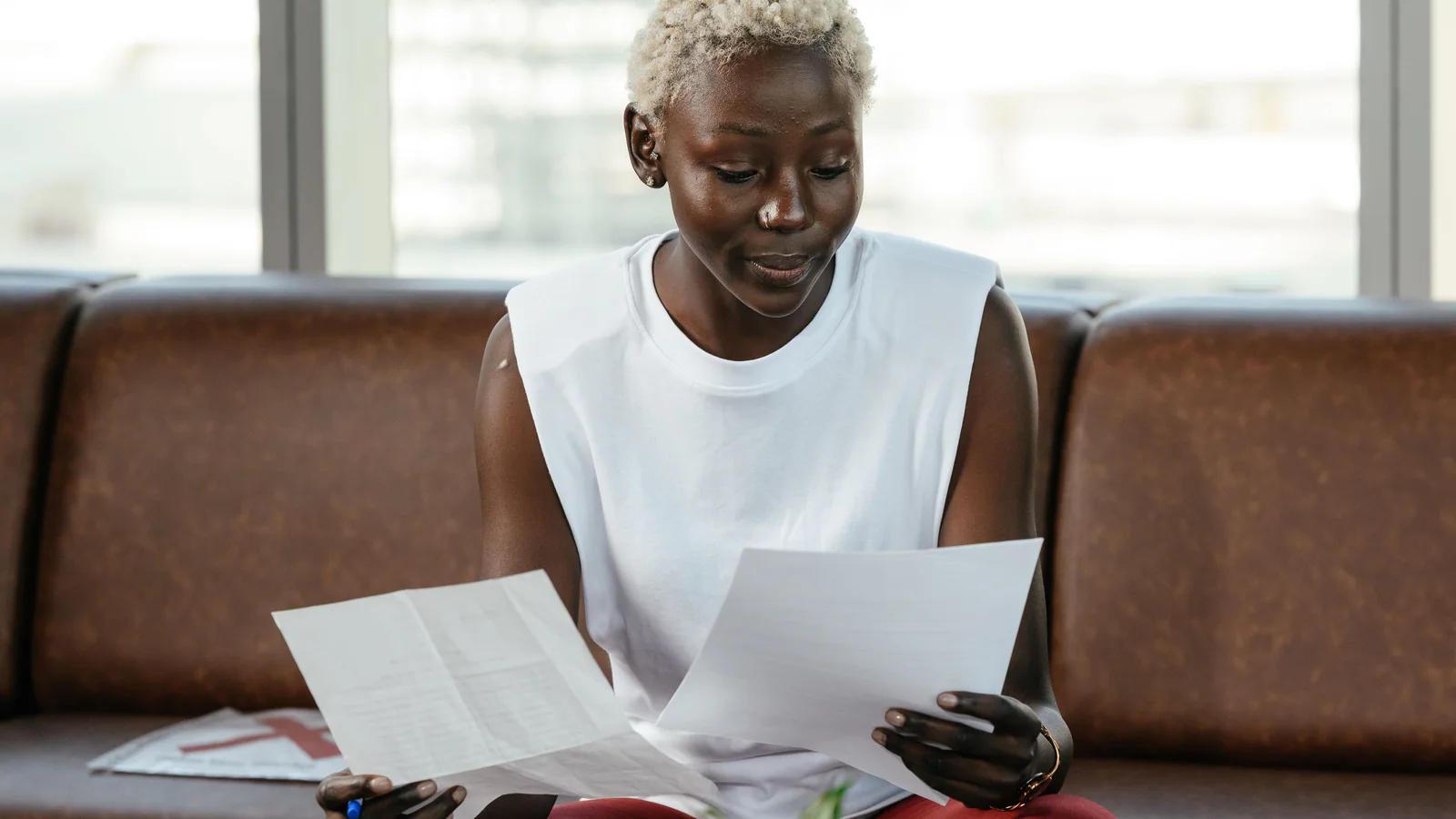 Person reviewing paper documents while preparing for a professional consultation