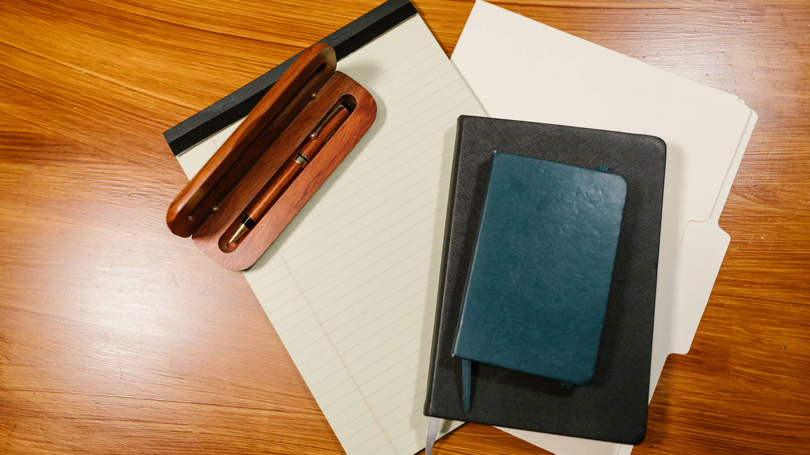 Blank documents, notebooks and a fountain pen on a desk