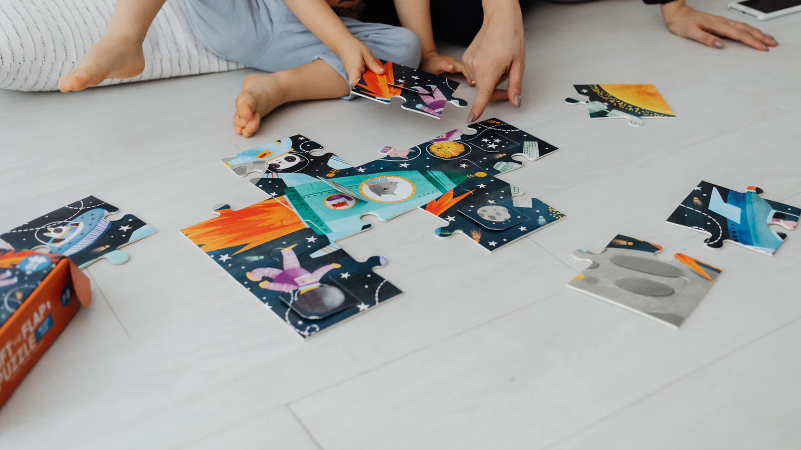 Adult and child assembling a floor puzzle together