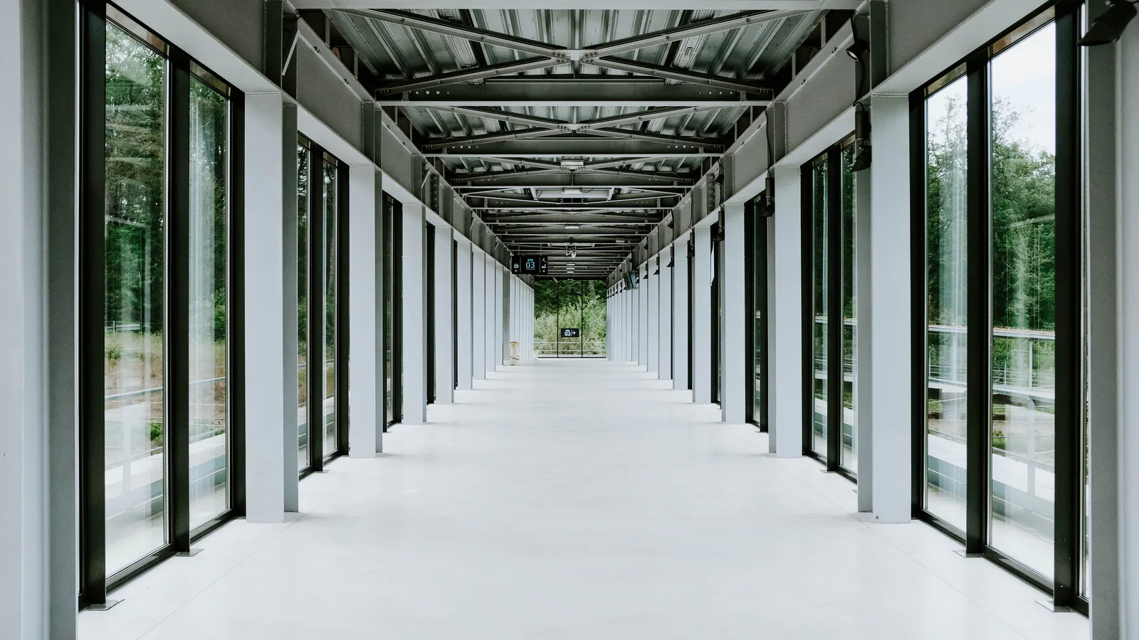 Empty glass corridor in a modern institutional building