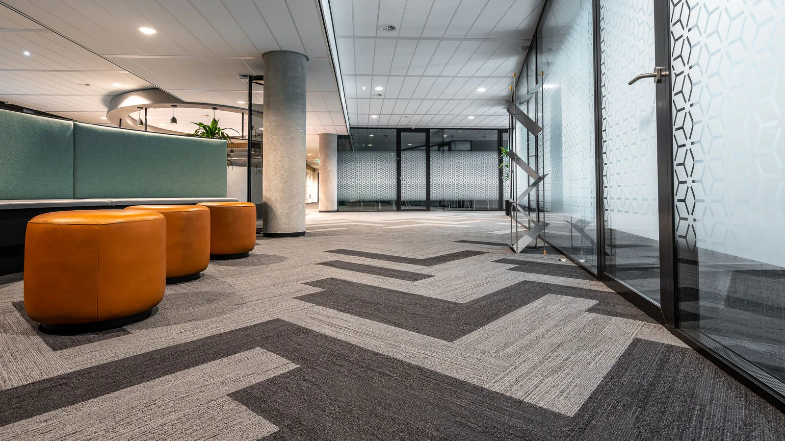 Empty modern office corridor with glass doors and open floor space